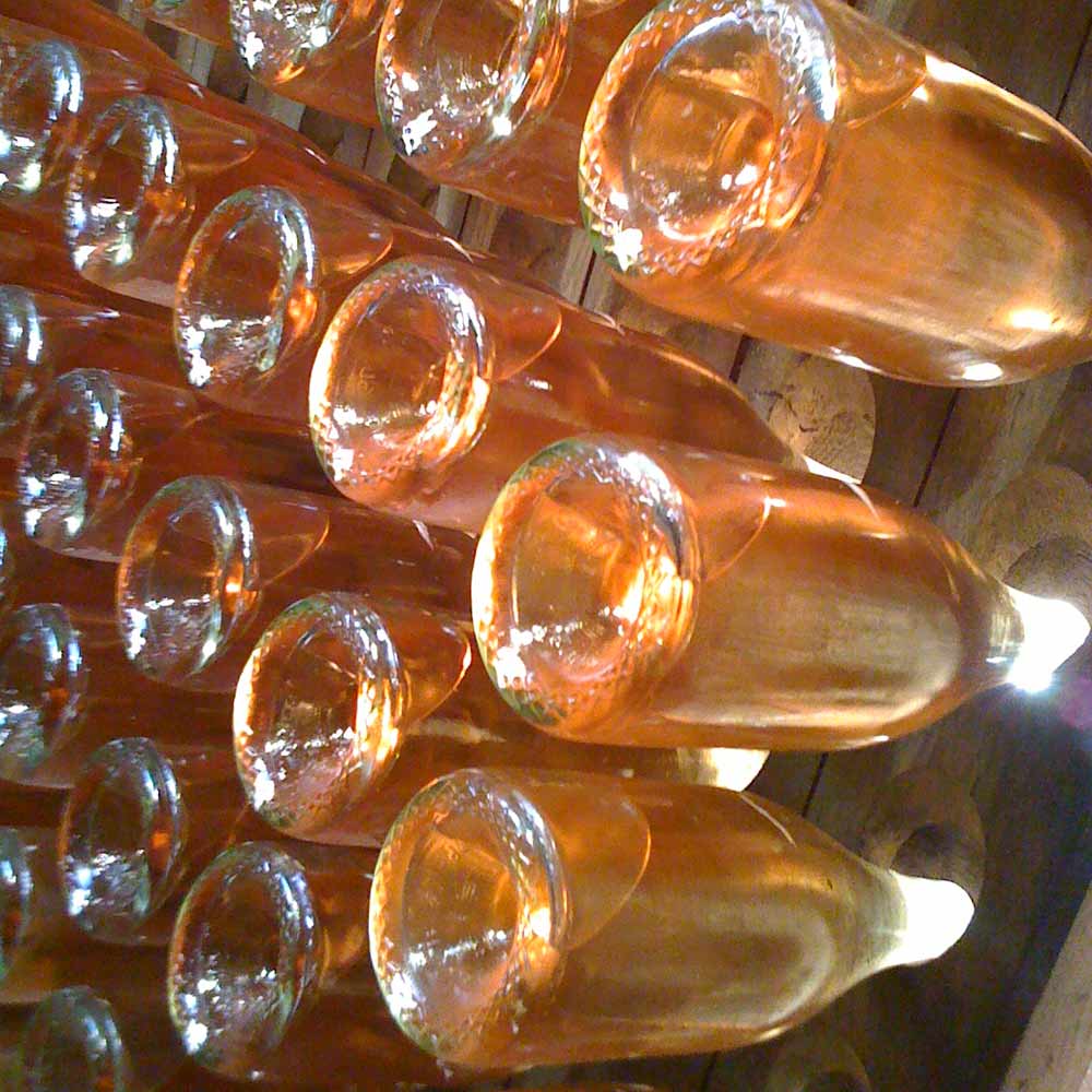 sparkling wine bottles in a riddling rack